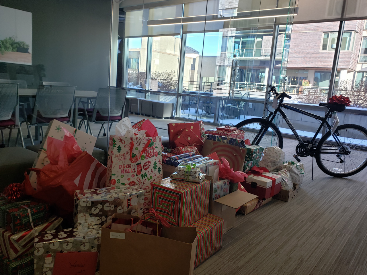 Top Colorado luxury real estate brokerage collected over 100 toys for children living at Bluff Lake, as well as 96 gifts for Colorado single mothers and 36 families with Be the Gift
