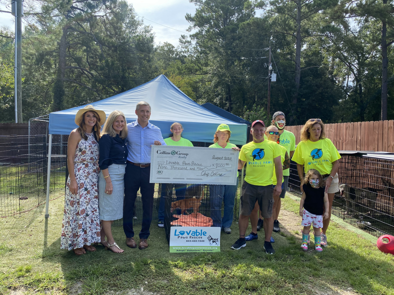 Pictured are Chip Collins, owner of Collins Group Realty, and his wife Carrie Collins, Ashley Lindblad, Director of Marketing and Community Relations of Collins Group Realty, Steve Allen, Director of Lovable Paws Rescue and members of his volunteer team.