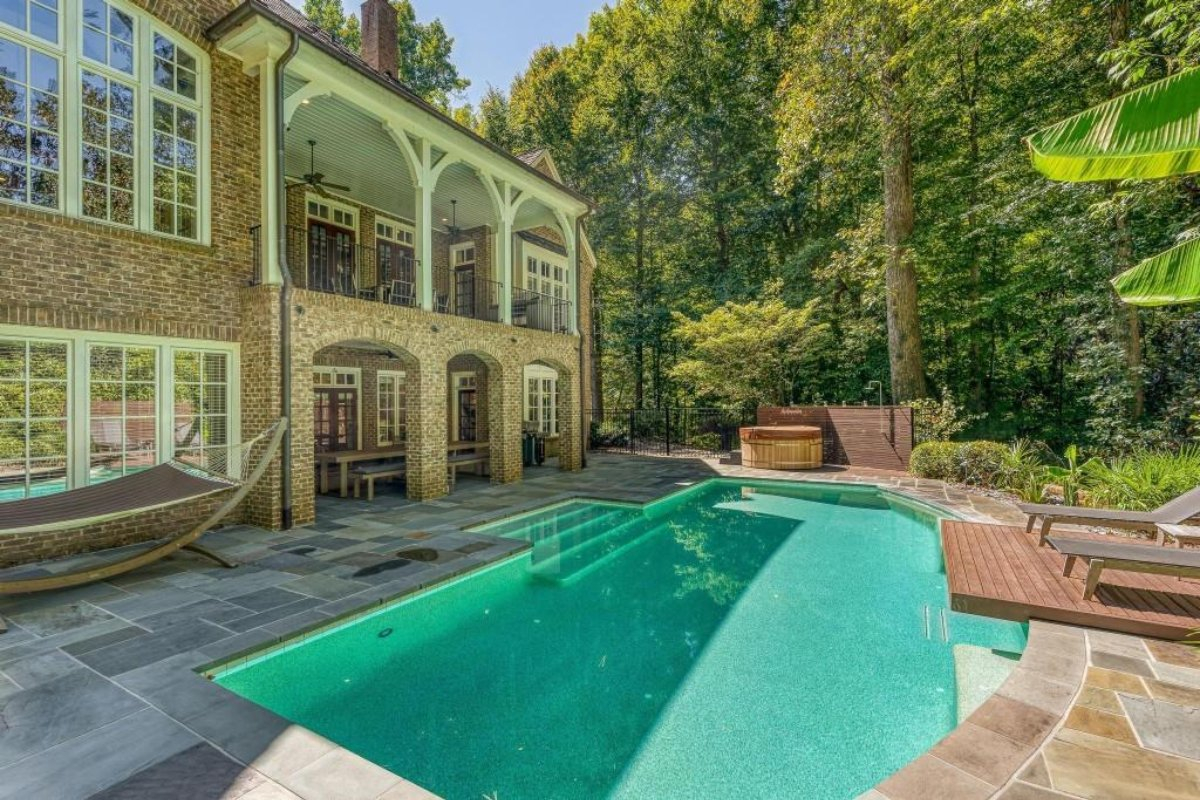 Buckhead estate with backyard featuring a salt water pool and unique tanning deck
