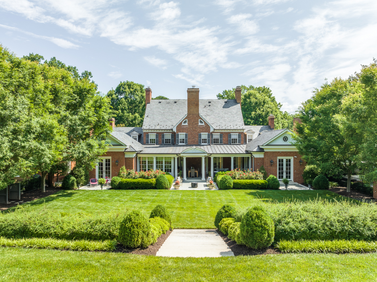 Expansive bluestone covered porch overlooks the meticulously landscaped grounds