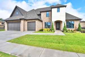 Gorgeous new construction in Jenks SE gated community with neighborhood pool.